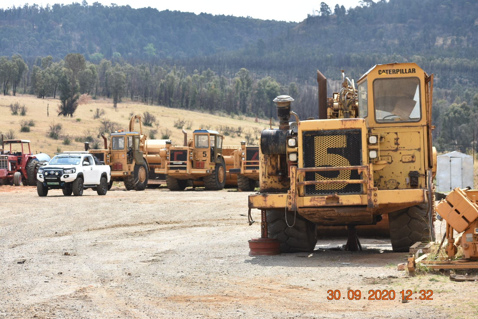 Caterpillar 621B Scraper with More in the Background